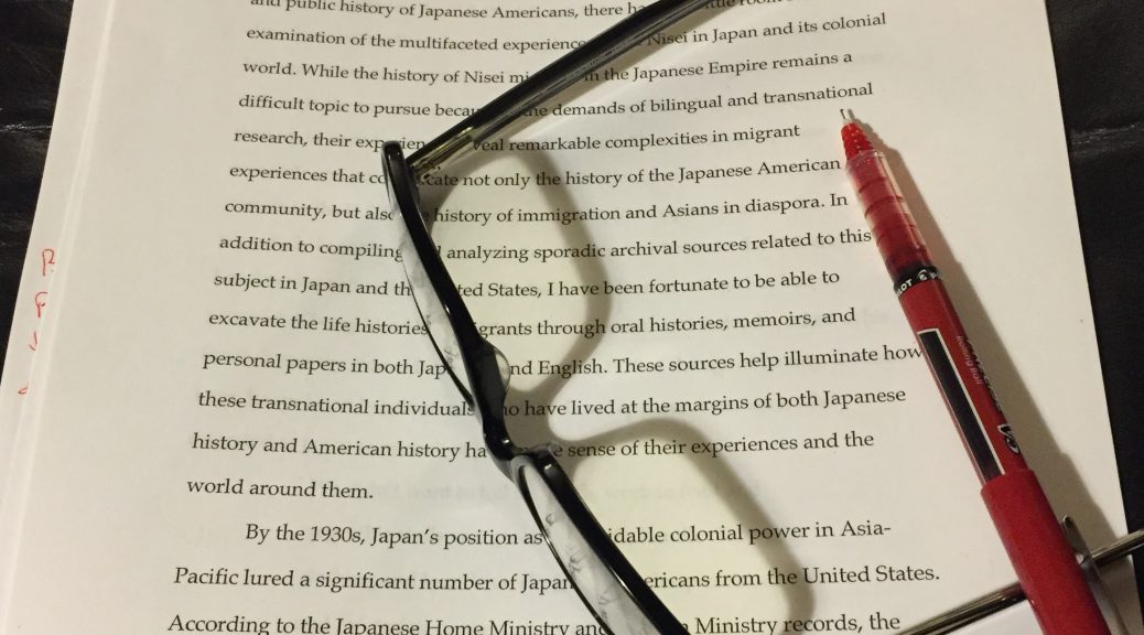 An essay, glasses and a red pen